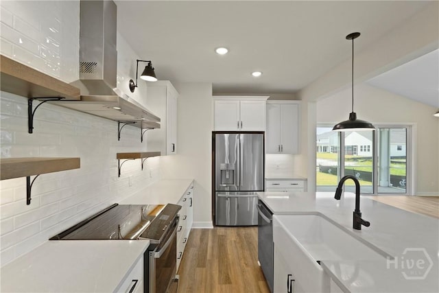 112 Mage St, Savannah, GA 31302 - kitchen featuring appliances with stainless steel finishes, decorative backsplash, island exhaust hood, light countertops, and decorative light fixtures