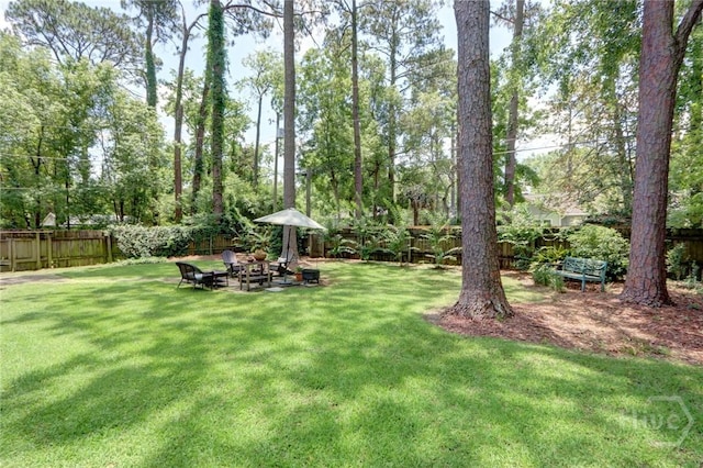 423 E 57th St, Savannah, GA 31405 - view of yard featuring view of wooded area and a fire pit