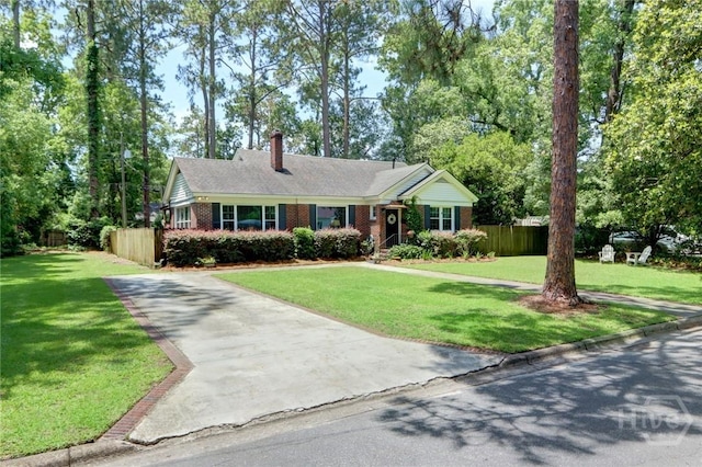 423 E 57th St, Savannah, GA 31405 - ranch-style house with brick siding, a chimney, driveway, and view of wooded area