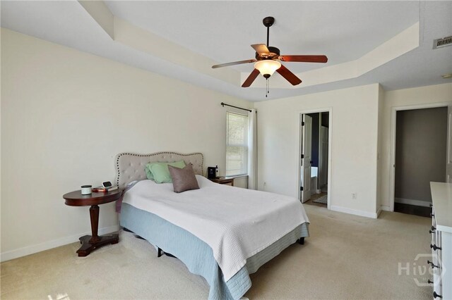 541 Deloach Rd NE, Ludowici, GA 31316 - bedroom with light colored carpet, baseboards, a raised ceiling, and ceiling fan
