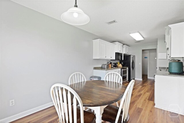 541 Deloach Rd NE, Ludowici, GA 31316 - dining space featuring baseboards and light wood-style flooring