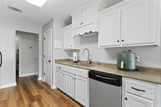 541 Deloach Rd NE, Ludowici, GA 31316 - kitchen featuring dishwasher, a sink, white cabinetry, dark wood-type flooring, and baseboards