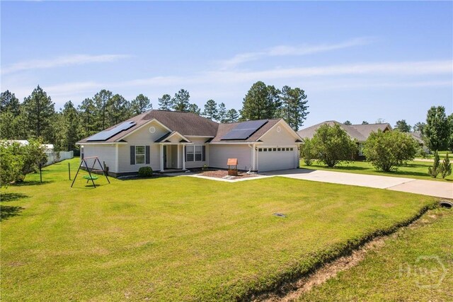 541 Deloach Rd NE, Ludowici, GA 31316 - ranch-style house featuring a garage, roof mounted solar panels, driveway, and a front yard