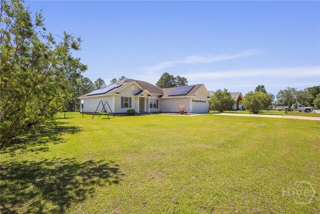 541 Deloach Rd NE, Ludowici, GA 31316 - ranch-style home featuring driveway, solar panels, a garage, and a front yard