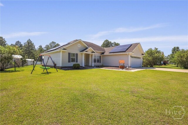 541 Deloach Rd NE, Ludowici, GA 31316 - ranch-style home with roof mounted solar panels, driveway, and an attached garage