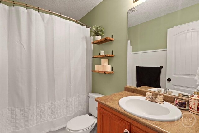 541 Deloach Rd NE, Ludowici, GA 31316 - bathroom featuring a textured ceiling, toilet, vanity, and a shower with shower curtain