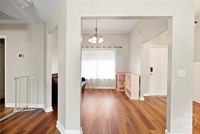 541 Deloach Rd NE, Ludowici, GA 31316 - corridor featuring wood finished floors, a chandelier, and baseboards