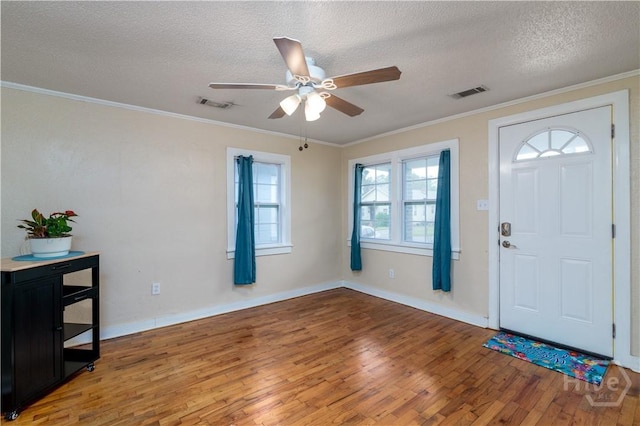 717 W 46th St, Savannah, GA 31405 - entryway with light wood finished floors, ceiling fan, a textured ceiling, crown molding, and baseboards