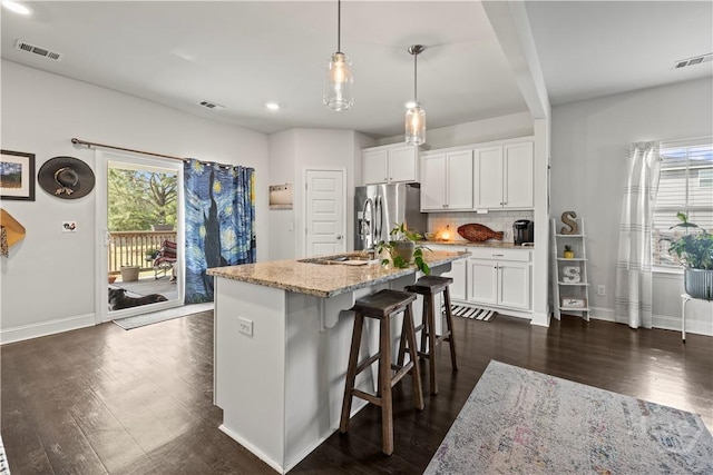 40 Saddlebrush Rd, Ellabell, GA 31308 - kitchen with stainless steel refrigerator with ice dispenser, dark wood-style flooring, healthy amount of natural light, baseboards, and recessed lighting