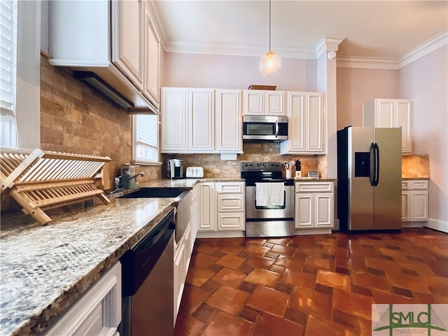 2203 Barnard St, Savannah, GA 31401 - kitchen with stainless steel appliances, ornamental molding, tasteful backsplash, a sink, and light stone counters