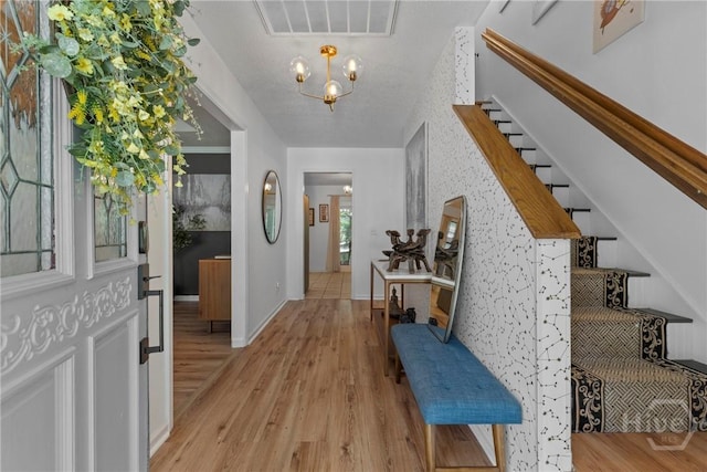 107 Rose Dhu Way, Savannah, GA 31419 - entrance foyer with a chandelier, stairway, light wood finished floors, and baseboards