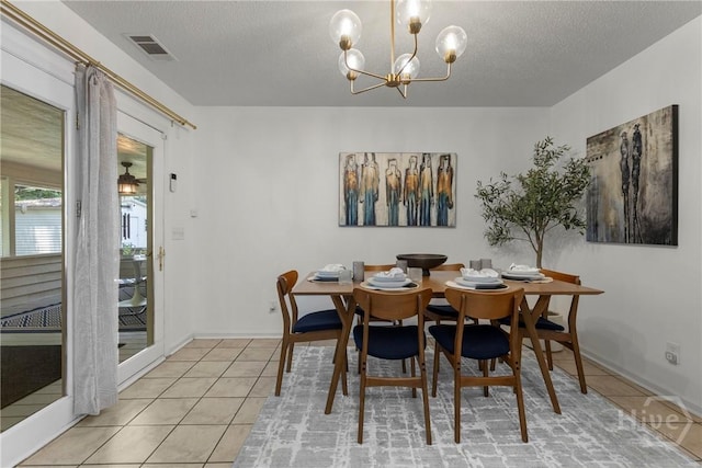 107 Rose Dhu Way, Savannah, GA 31419 - dining area featuring light tile patterned floors, a chandelier, a textured ceiling, and baseboards