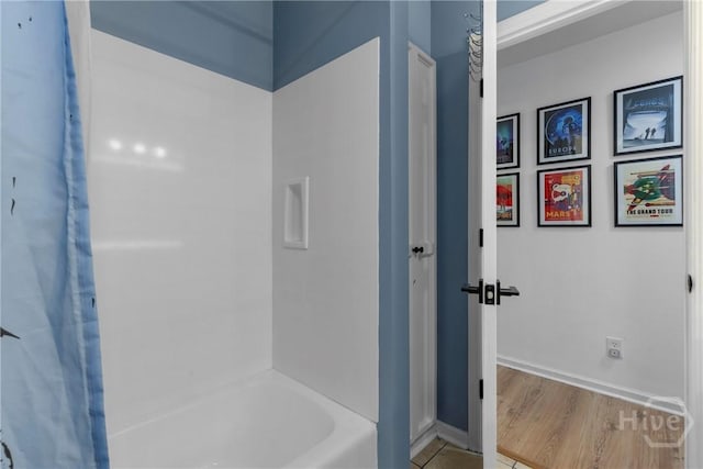 107 Rose Dhu Way, Savannah, GA 31419 - bathroom featuring shower / bath combination with curtain, baseboards, and wood finished floors