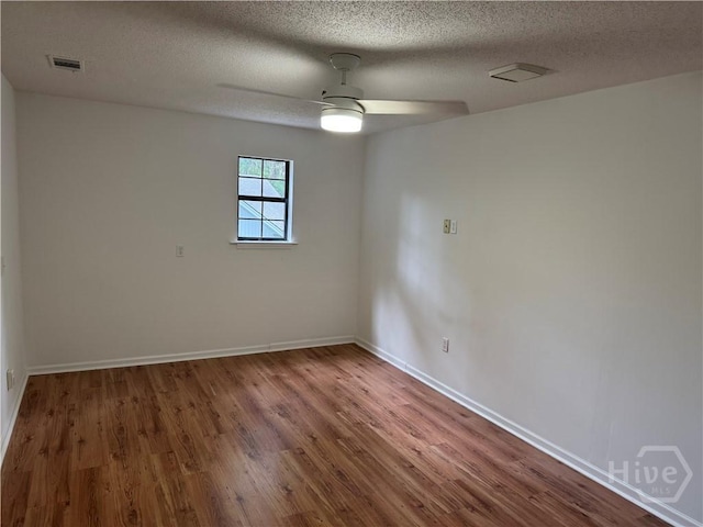 107 Rose Dhu Way, Savannah, GA 31419 - empty room with wood finished floors, a textured ceiling, a ceiling fan, and baseboards