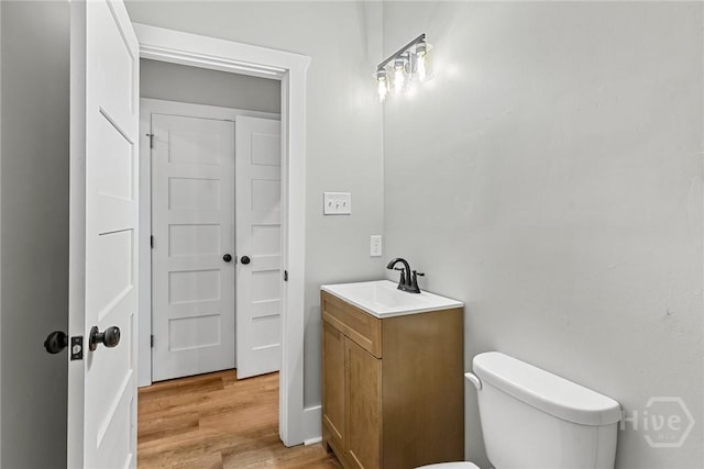 1825 Lloyd St, Savannah, GA 31405 - half bath with vanity, toilet, and wood finished floors