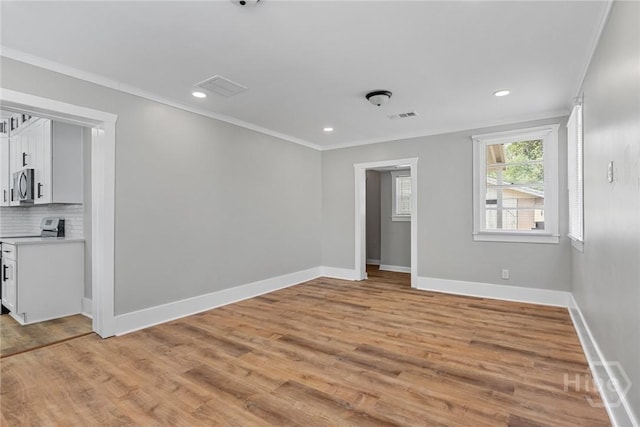 1825 Lloyd St, Savannah, GA 31405 - spare room with crown molding, baseboards, light wood finished floors, and recessed lighting