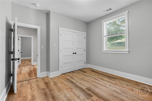 1825 Lloyd St, Savannah, GA 31405 - unfurnished bedroom with light wood-type flooring, baseboards, and a closet