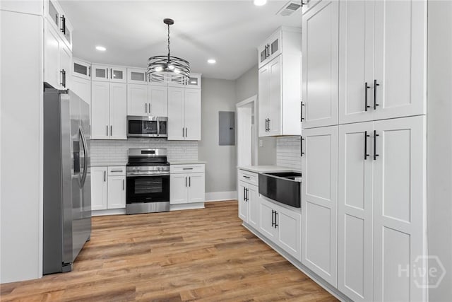 1825 Lloyd St, Savannah, GA 31405 - kitchen featuring appliances with stainless steel finishes, decorative backsplash, a sink, white cabinets, and recessed lighting