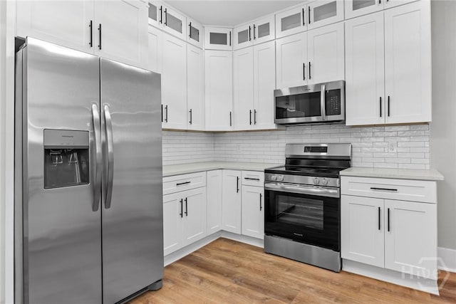 1825 Lloyd St, Savannah, GA 31405 - kitchen with stainless steel appliances, light countertops, light wood finished floors, and white cabinets