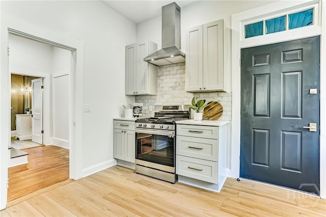 1001 Maupas Ave, Savannah, GA 31401 - kitchen with stainless steel range with gas cooktop, ventilation hood, tasteful backsplash, light countertops, and light wood finished floors