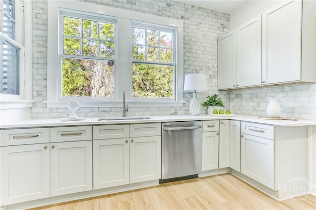 1001 Maupas Ave, Savannah, GA 31401 - kitchen featuring stainless steel dishwasher, a sink, decorative backsplash, and light countertops