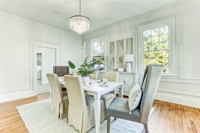 1001 Maupas Ave, Savannah, GA 31401 - dining space featuring a decorative wall, a chandelier, and wood finished floors