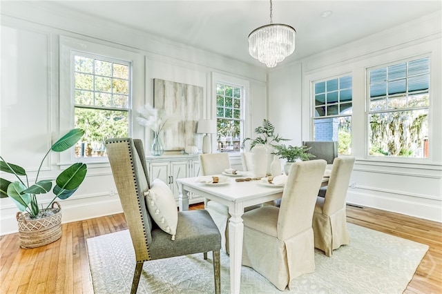 1001 Maupas Ave, Savannah, GA 31401 - dining room with a decorative wall, a chandelier, and wood finished floors