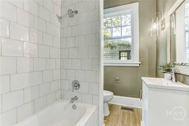 1001 Maupas Ave, Savannah, GA 31401 - bathroom with vanity, toilet, baseboards, shower / bath combination, and wood finished floors
