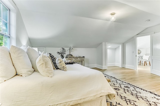 1001 Maupas Ave, Savannah, GA 31401 - bedroom with lofted ceiling, light wood finished floors, and baseboards