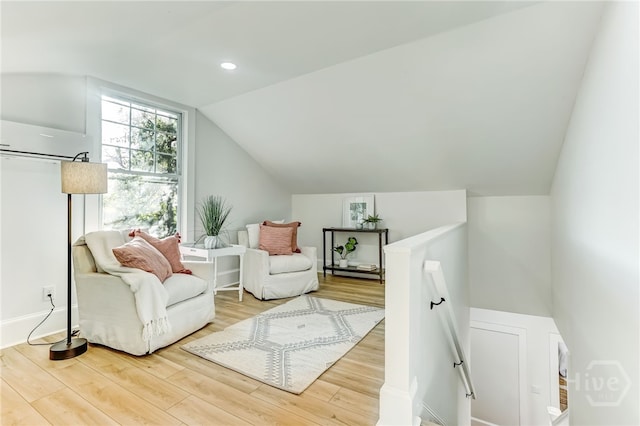 1001 Maupas Ave, Savannah, GA 31401 - sitting room with an upstairs landing, vaulted ceiling, wood finished floors, recessed lighting, and an AC wall unit