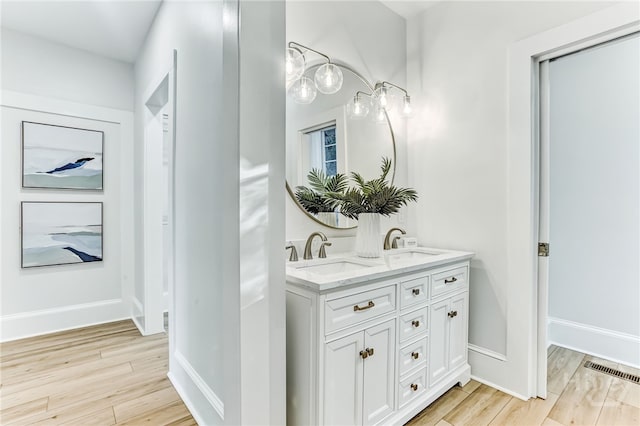 1001 Maupas Ave, Savannah, GA 31401 - full bath with double vanity, wood finished floors, and baseboards