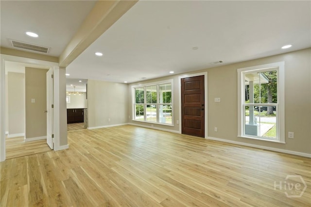 40 Circle Dr, Pembroke, GA 31321 - unfurnished living room featuring light wood-style flooring, plenty of natural light, recessed lighting, and a chandelier