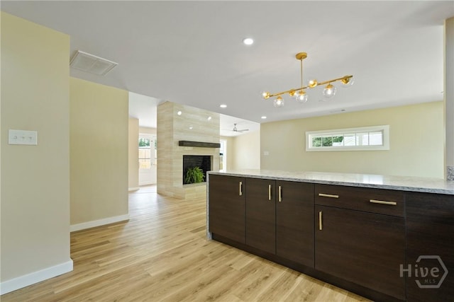 40 Circle Dr, Pembroke, GA 31321 - kitchen with dark brown cabinetry, light wood-type flooring, healthy amount of natural light, and recessed lighting