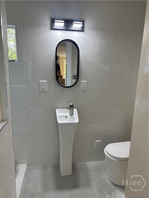 40 Circle Dr, Pembroke, GA 31321 - bathroom with tile walls, a shower, and tile patterned floors