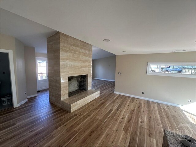 40 Circle Dr, Pembroke, GA 31321 - unfurnished living room featuring wood finished floors and a tiled fireplace