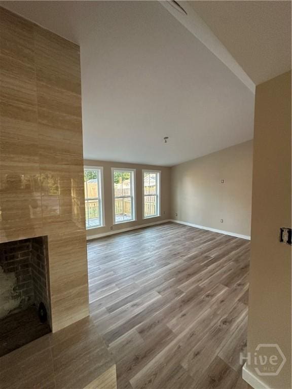 40 Circle Dr, Pembroke, GA 31321 - unfurnished living room with a large fireplace and wood finished floors