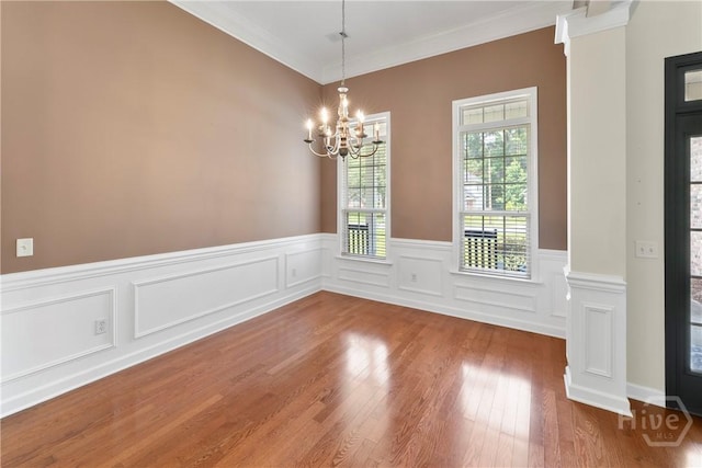 201 Henderson Oaks Dr, Savannah, GA 31419 - unfurnished dining area featuring ornamental molding, a chandelier, a wainscoted wall, and wood finished floors