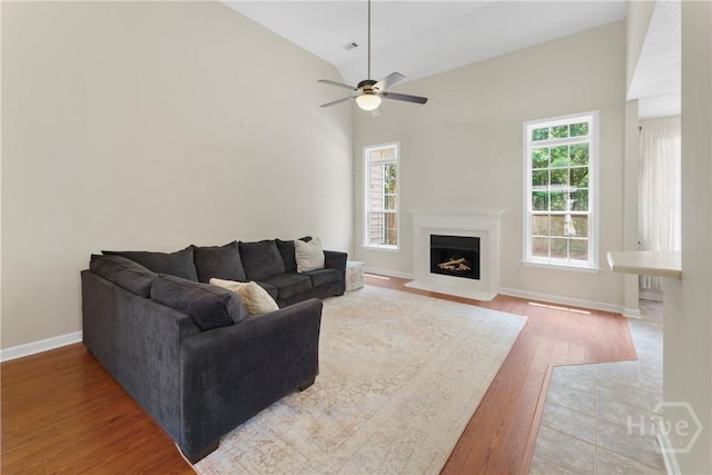 201 Henderson Oaks Dr, Savannah, GA 31419 - living area with wood finished floors, a fireplace with flush hearth, ceiling fan, baseboards, and high vaulted ceiling