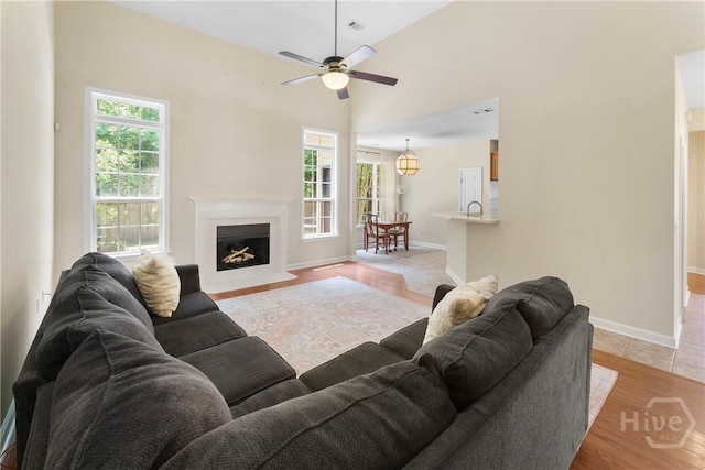 201 Henderson Oaks Dr, Savannah, GA 31419 - living room with ceiling fan, light wood finished floors, a fireplace with flush hearth, and baseboards