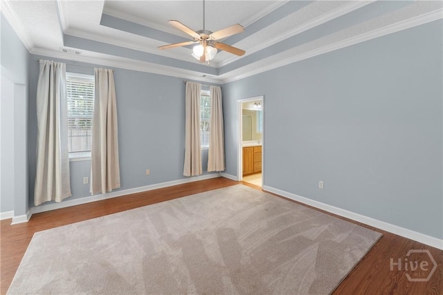 201 Henderson Oaks Dr, Savannah, GA 31419 - unfurnished bedroom featuring a tray ceiling, wood finished floors, ornamental molding, baseboards, and ensuite bath