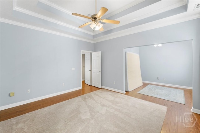 201 Henderson Oaks Dr, Savannah, GA 31419 - unfurnished bedroom featuring a raised ceiling, ornamental molding, wood finished floors, baseboards, and a ceiling fan