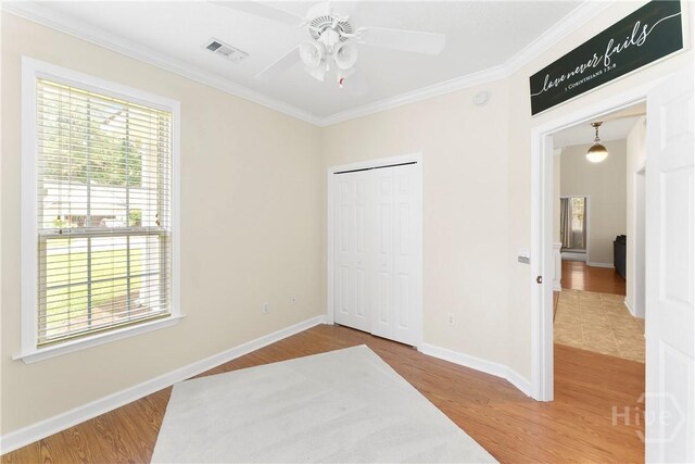 201 Henderson Oaks Dr, Savannah, GA 31419 - unfurnished bedroom featuring crown molding, wood finished floors, a closet, baseboards, and ceiling fan