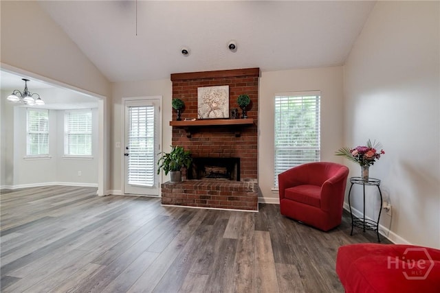 19 S Lake Dr, Savannah, GA 31410 - living area with vaulted ceiling, wood finished floors, a fireplace, plenty of natural light, and a chandelier