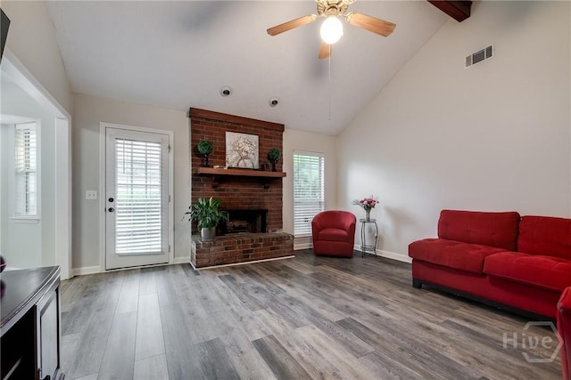 19 S Lake Dr, Savannah, GA 31410 - living room featuring high vaulted ceiling, plenty of natural light, a fireplace, wood finished floors, and a ceiling fan