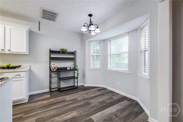 19 S Lake Dr, Savannah, GA 31410 - dining space featuring dark wood-type flooring, a chandelier, baseboards, and a textured ceiling