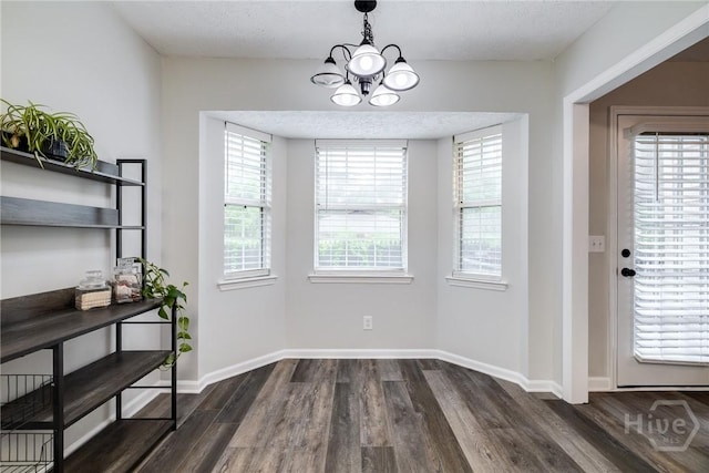 19 S Lake Dr, Savannah, GA 31410 - unfurnished dining area featuring dark wood finished floors, a chandelier, plenty of natural light, and baseboards