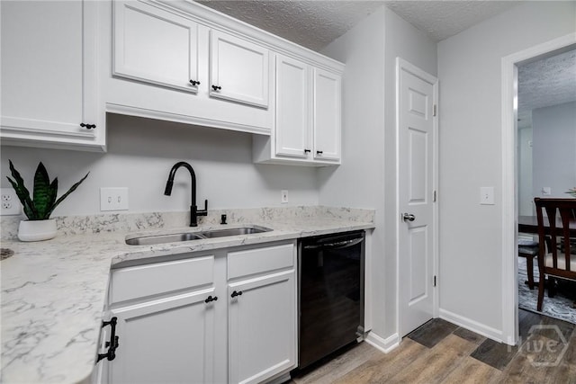 19 S Lake Dr, Savannah, GA 31410 - kitchen with black dishwasher, a sink, wood finished floors, a textured ceiling, and white cabinets