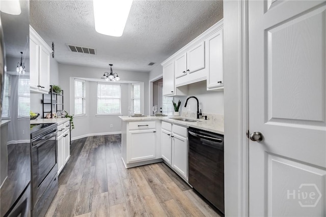 19 S Lake Dr, Savannah, GA 31410 - kitchen featuring black dishwasher, electric range oven, a sink, a chandelier, and a peninsula
