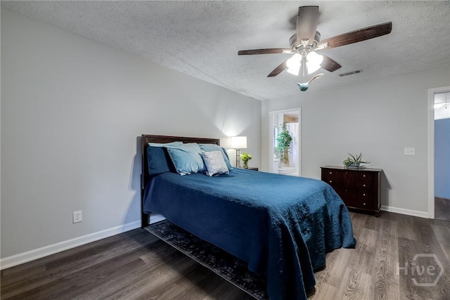 19 S Lake Dr, Savannah, GA 31410 - bedroom with a textured ceiling, wood finished floors, baseboards, and a ceiling fan