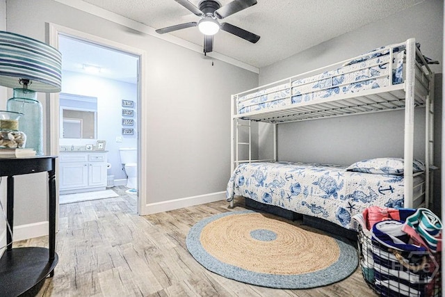 111 Runner Rd, Savannah, GA 31410 - bedroom featuring wood finished floors, ensuite bathroom, baseboards, a textured ceiling, and ceiling fan